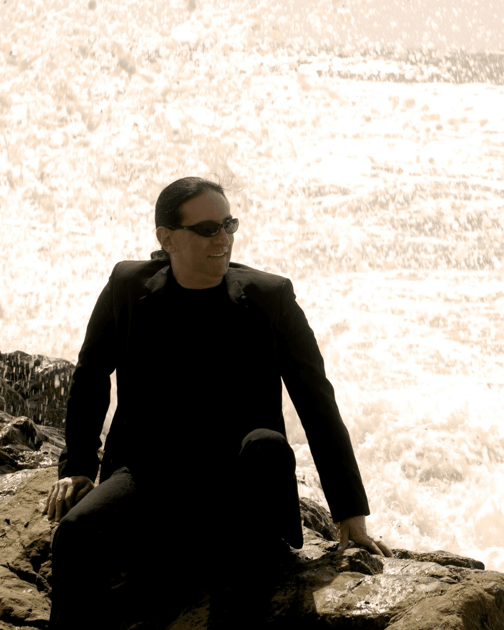 Rich seated beside a waterfall